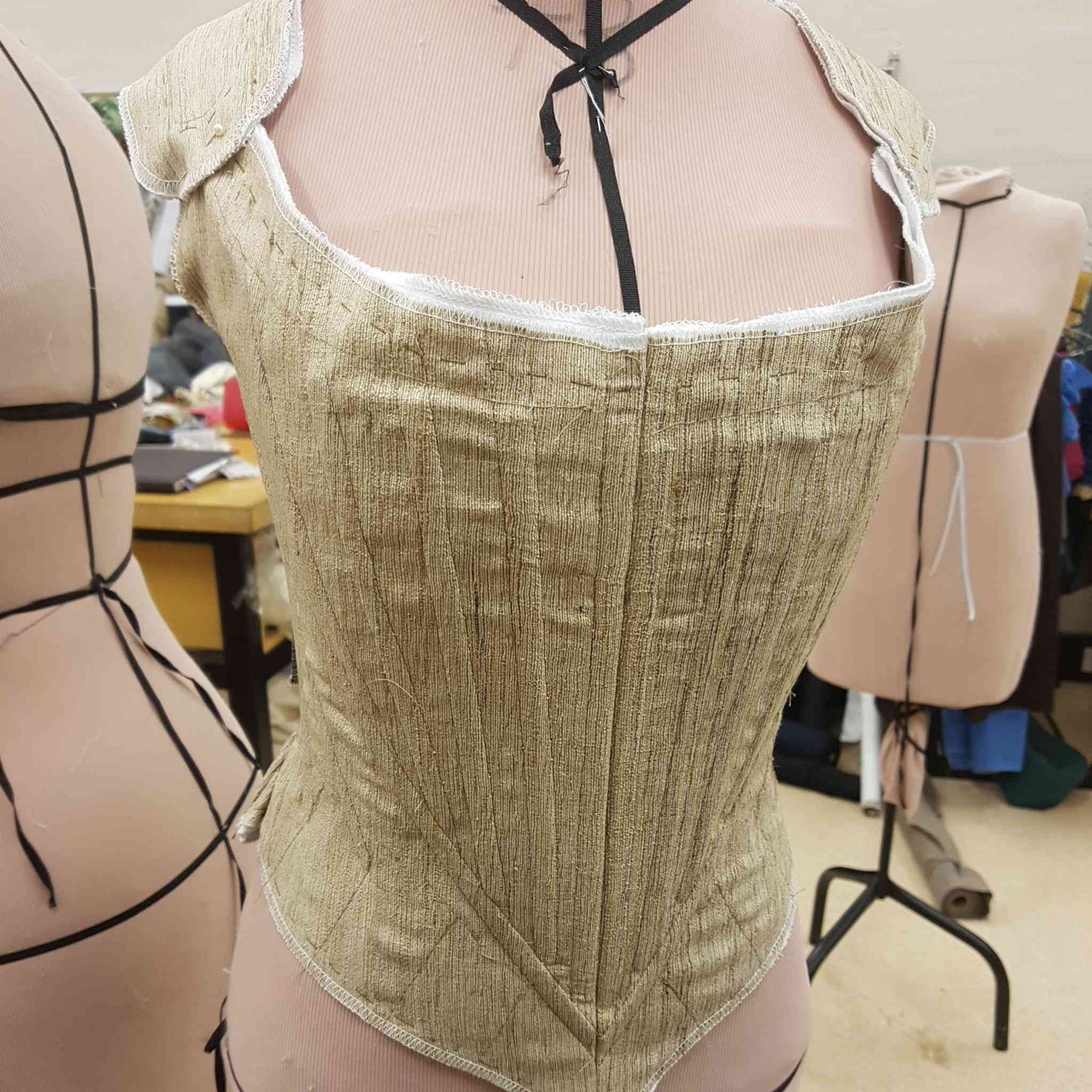 https://www.bobbinandink.com/cdn/shop/products/make-your-own-corsets-and-stays-bobbin-and-ink-sewing-course-front-unfinished_1445x.jpg?v=1664169931